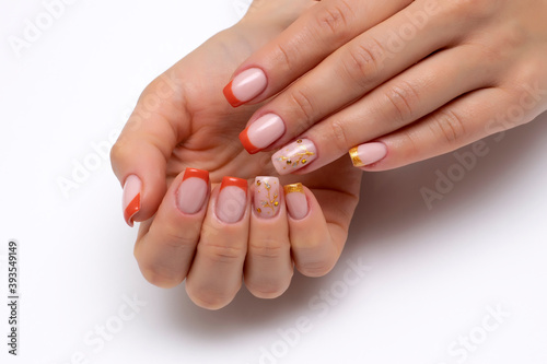 Autumn orange French manicure with golden tree and crystals on long square nails on a white background close up