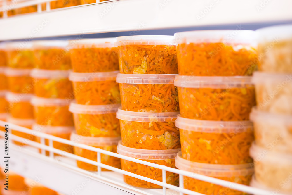 pickled carrots in plastic cans in supermarket pickled carrots in plastic cans in supermarket