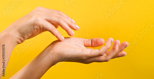 Beautiful woman hands. Female hands applying cream. Female hands with pastel manicure. Soft skin, skincare concept. Hand Skin Care.