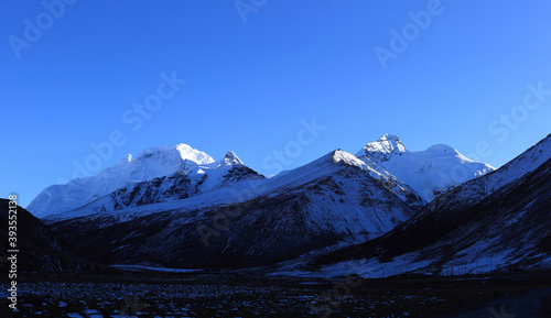 Snow mountains under blue sky in tibet China