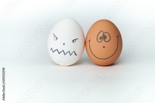 two eggs with drawn smiley faces