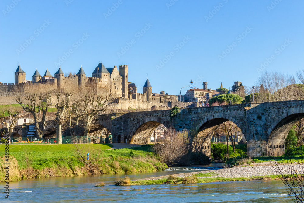 The River Aude and Old Bridge (Pont Vieux, 14th Cent) leading to Medieval town of Carcassonne (Cité), Languedoc-Roussillon, France.
