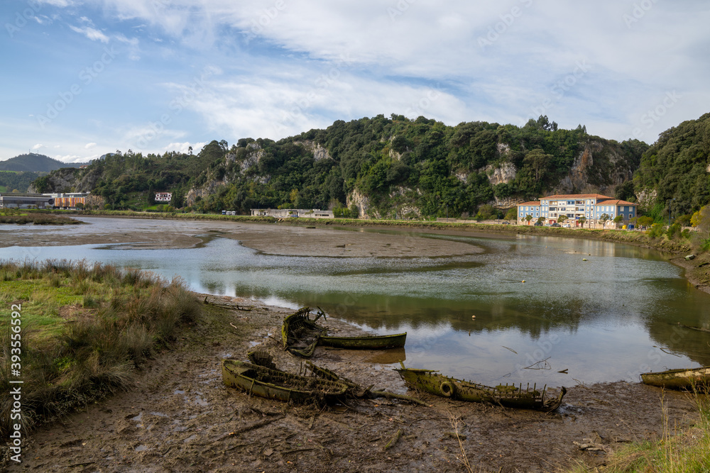 view of the estuary of the Sella River in Asturias at low tide with old row boat wrecks