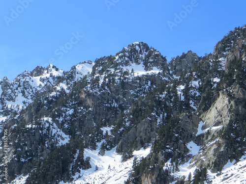 Peaceful nature view of Gaube Valley with amazing snow-capped mountain range background in the French Pyrenees, in the department of the Hautes-Pyrénées, near the town of Cauterets, France.