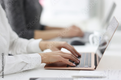 Female hands work on laptops in office. Learning and education computer courses concept