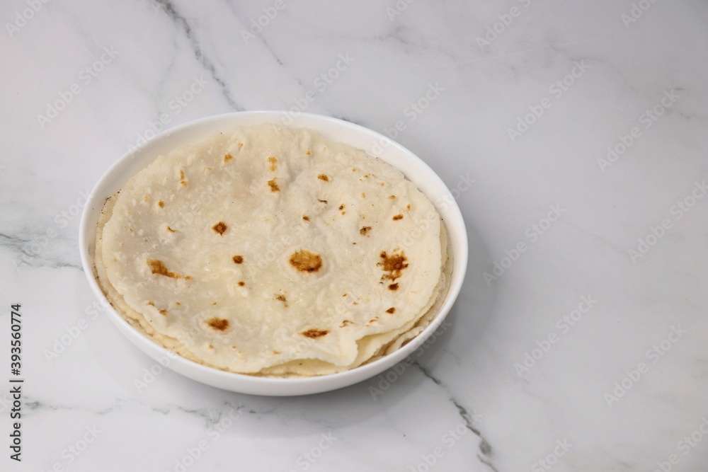 Rice bhakri, Chawal ki roti. It is a round soft flatbread. Usually eaten with fish, chicken or mutton thali. Served with garlic & green chutney. Copy space. Rice bhakri, Chawal ki roti. It is a round soft flatbread. Usually eaten with fish, chicken or mutton thali. Served with garlic & green chutney. Copy space.