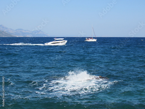Boat on Turkish Mediterranean seaside landscape with mountains.