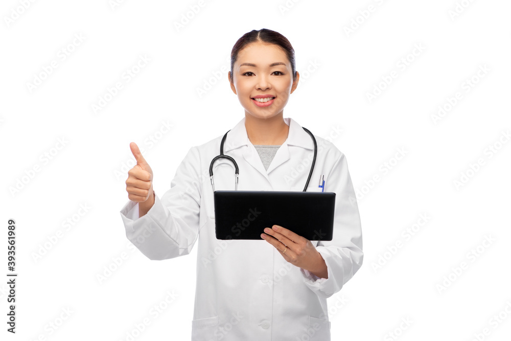 medicine, profession and healthcare concept - happy smiling asian female doctor in white coat with tablet pc computer and stethoscope showing thumbs up medicine, profession and healthcare concept - happy smiling asian female doctor in white coat with tablet pc computer and stethoscope showing thumbs up