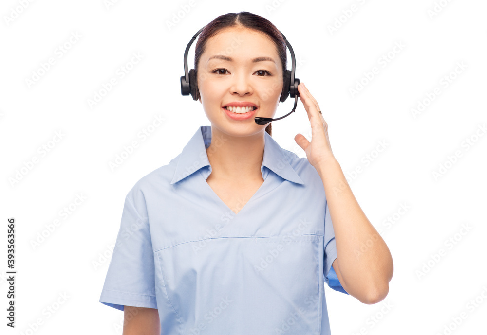 medicine, profession and healthcare concept - happy smiling asian female doctor or nurse in blue uniform and headset over white background medicine, profession and healthcare concept - happy smiling asian female doctor or nurse in blue uniform and headset over white background