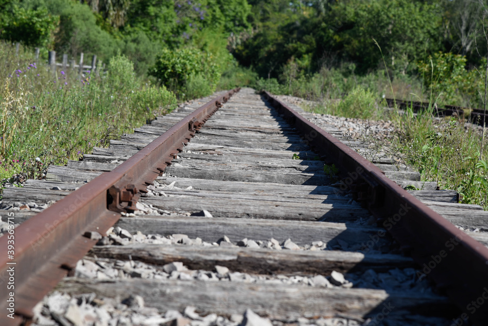 Old and abandoned railway and rails with rusty wooden sleepers in Brazil Old and abandoned railway and rails with rusty wooden sleepers in Brazil