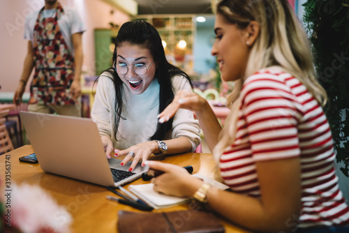 Amazed Asian hipster girl in trendy glasses shocked with received discount newsletter surprised with Black Friday shopping  female freelancer discussing projecting success during laptop browsing