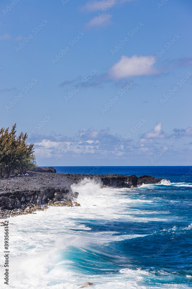 Rocky coast of Reunion Island with waves breaking