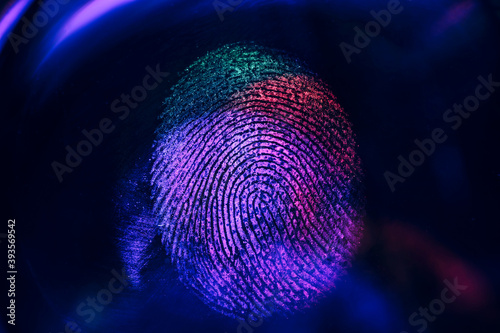 Close up beautiful abstract neon colored fingerprint on  background texture for design. Macro photography view.