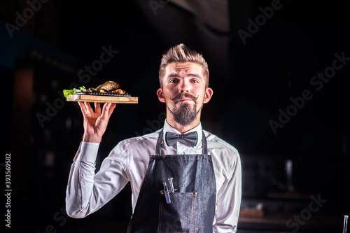 Professional friendly flunky helpfully serves salad at a festive event. photo