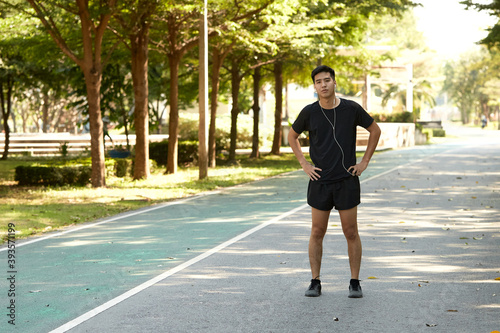 A young man walks outdoor as workout