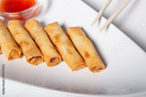 Fried elastic rolls on a white plate