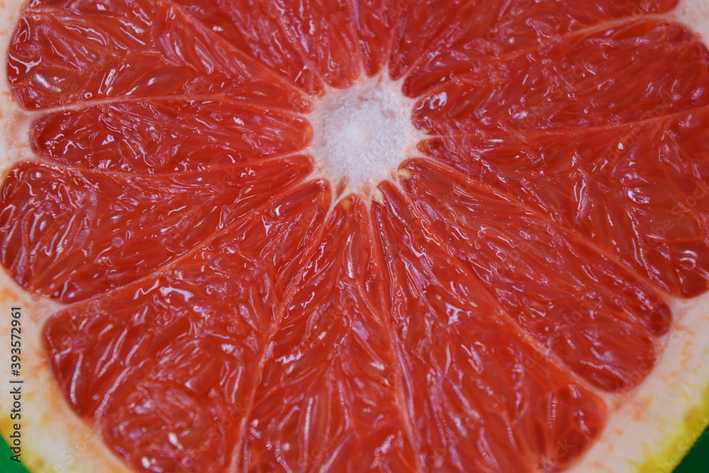 Ripe and tasty fruits, fresh grapefruit cut in half, sliced grapefruit set on a green fabric background. Ripe and tasty fruits, fresh grapefruit cut in half, sliced grapefruit set on a green fabric background.