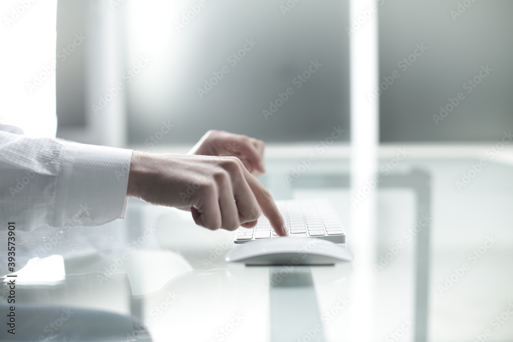 Man's hands are typing on the keyboard