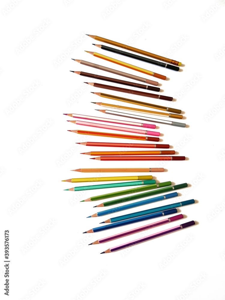Colored pencils arranged in a row on a white background Colored pencils arranged in a row on a white background