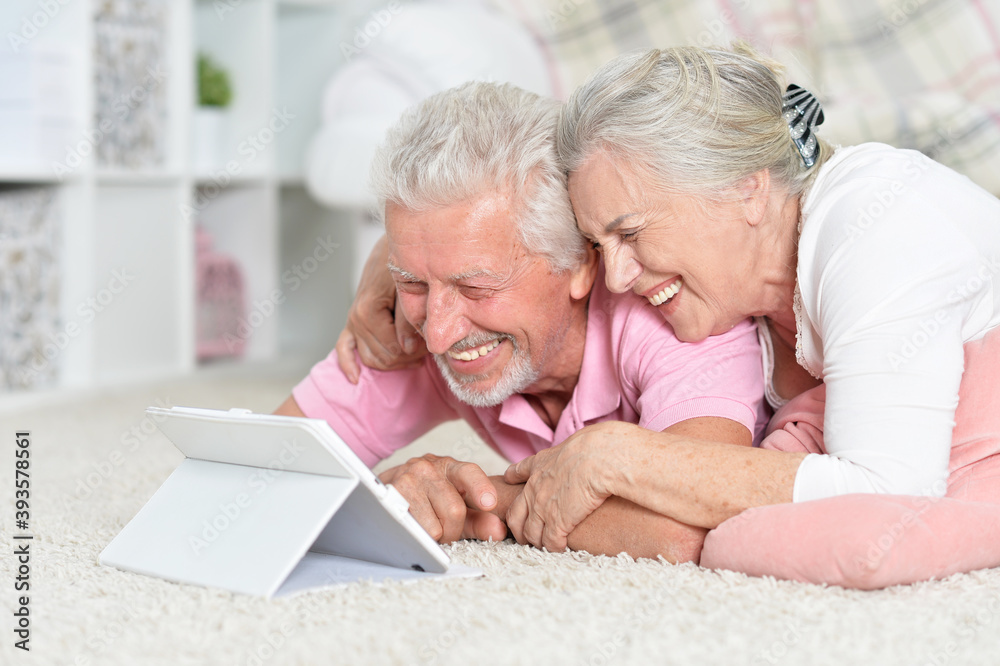 Happy senior couple using tablet at home Happy senior couple using tablet at home
