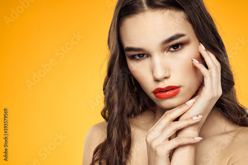 beautiful brunette red lips bare shoulders skin care yellow background