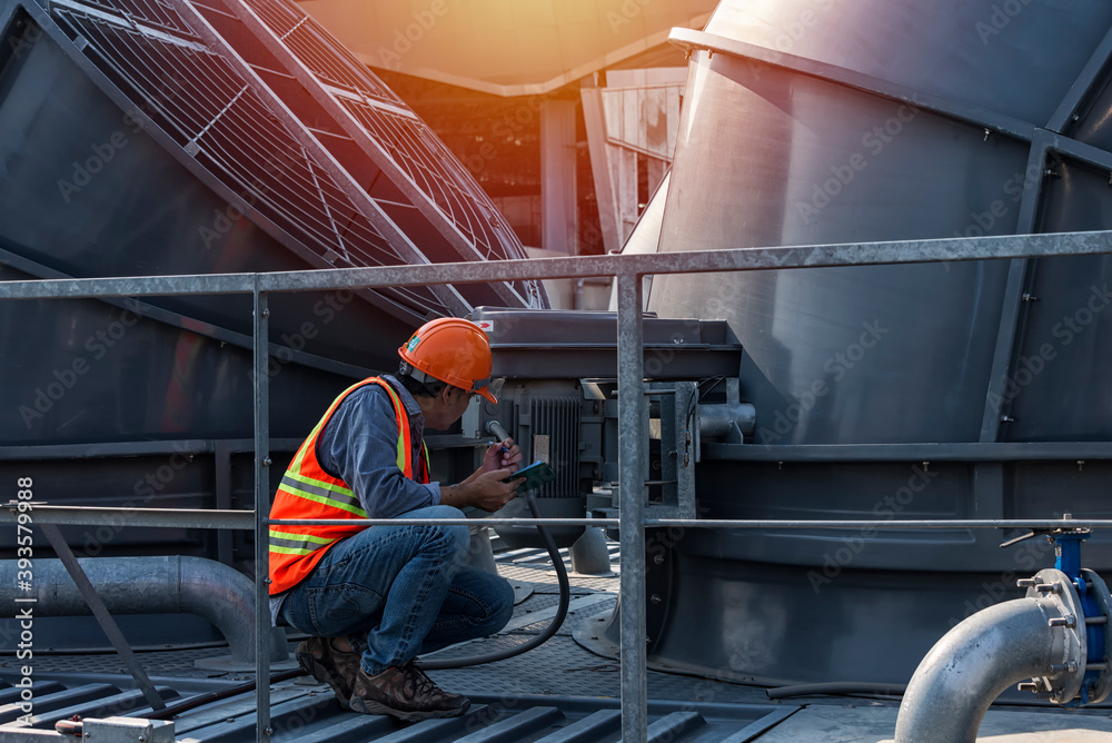 worker open valve of cooling tower on blue sky background. worker