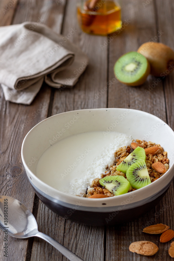 Muesli with white yogurt, kiwi and coconut. Granola. Healthy eating. Vegetarian food. Breakfast. Muesli with white yogurt, kiwi and coconut. Granola. Healthy eating. Vegetarian food. Breakfast.