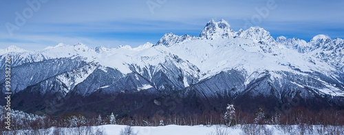 Panoramic view on high snowy mountains in winter at sunny day. Caucasus Mountains, Mount Ushba. Svaneti region of Georgia