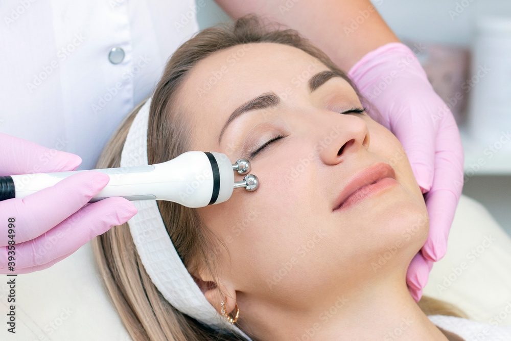 Hardware cosmetology. young woman with closed eyes receiving rf lifting procedure in beauty salon. Hardware cosmetology. young woman with closed eyes receiving rf lifting procedure in beauty salon.