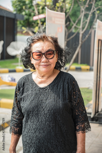 Portrait photo of beautiful senior asia women wearing sunglass with beautiful hair