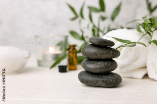 hot stone massage - spa beauty treatment items on white wooden table