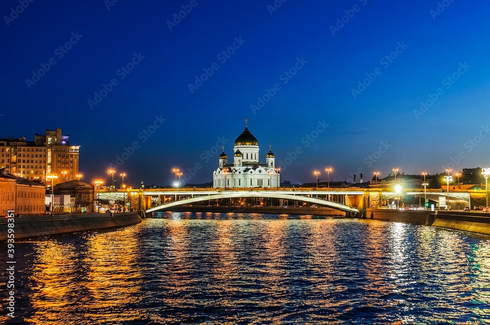 View of the Big Stone Bridge and the Cathedral of Christ the Savior in the late evening in August from the Moscow River. Moscow, Russia.