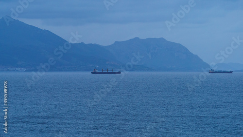 Soft blue sunset over the Atlantic ocean in the north Spain near Bilbao city. Ships in the water area. Natural bright backgrounds.