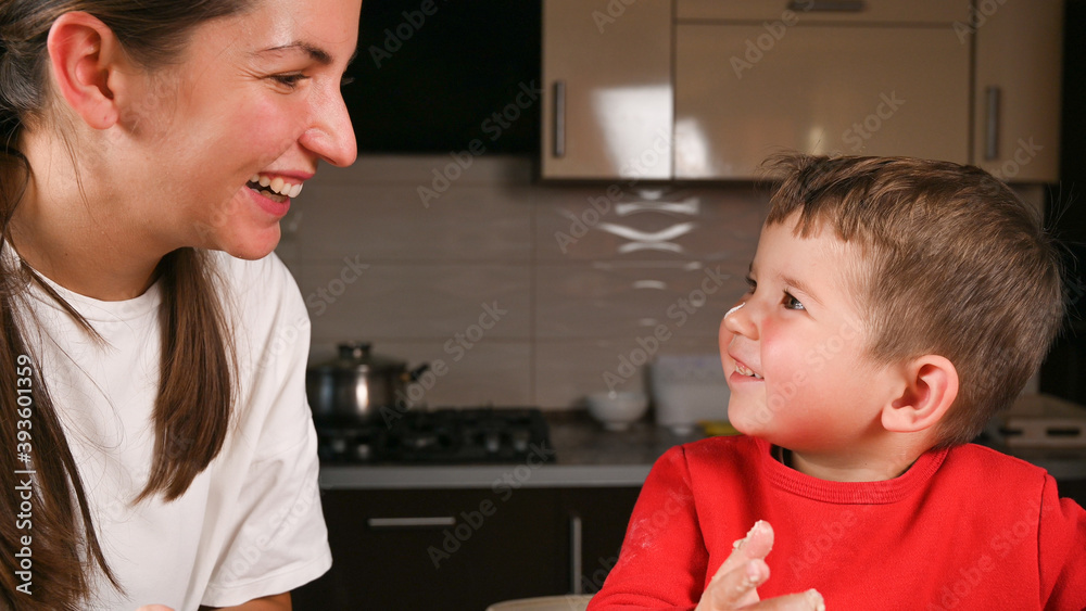 Mom and child laugh in the kitchen Mom and child laugh in the kitchen