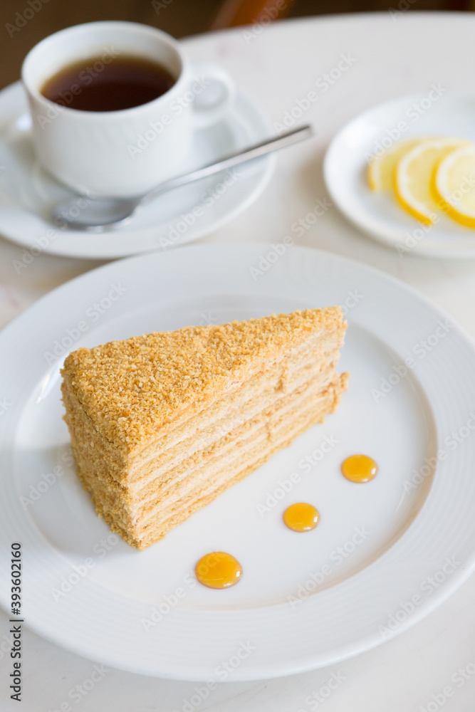 Slice of honey cake served with tea Slice of honey cake served with tea
