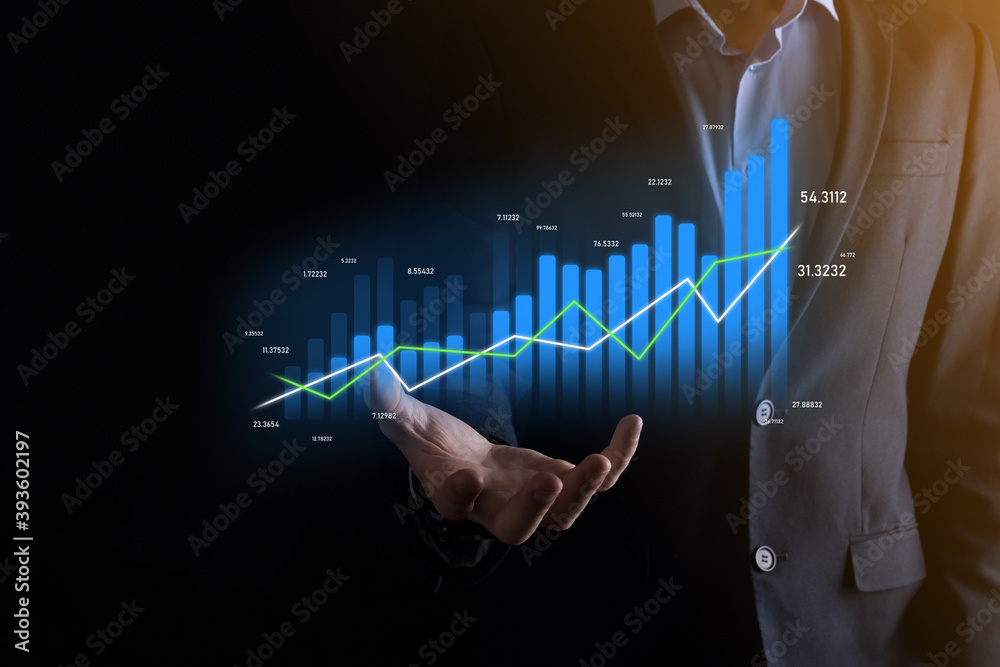 Business man holding holographic graphs and stock market statistics gain profits. Concept of growth planning and business strategy. Display of good economy form digital screen. Business man holding holographic graphs and stock market statistics gain profits. Concept of growth planning and business strategy. Display of good economy form digital screen.