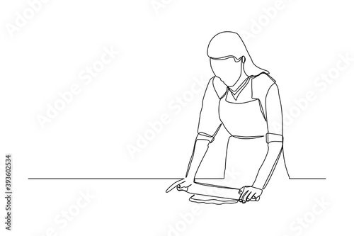 Continuous line drawing of chef woman rolling bakery pizza dough use wooden rolling pins. One line concept of bake receipt cooking. Vector illustration