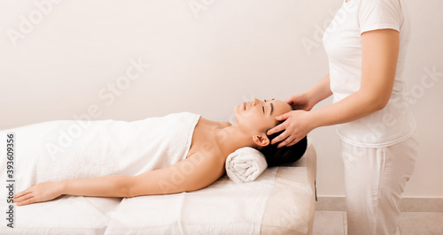 Thai massage. Asian woman during anti-stress head massage in spa salon