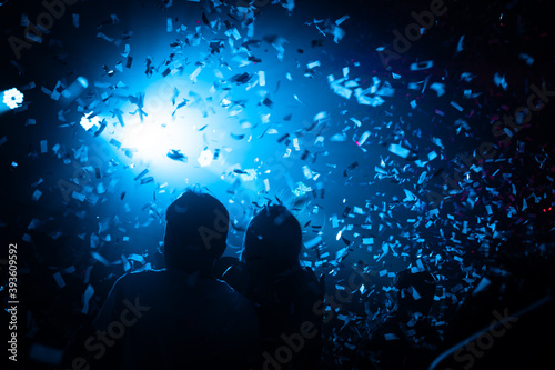 Silhouette of people at a party with confetti. Night Club