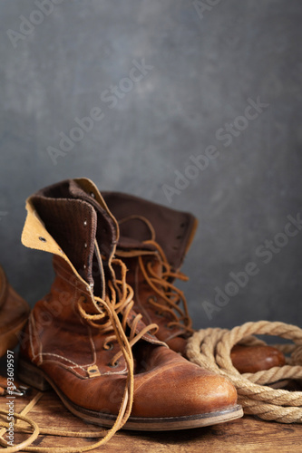 old leather travel vintage boots shoes and bag at table