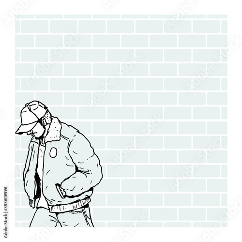 person sitting on a brick wall