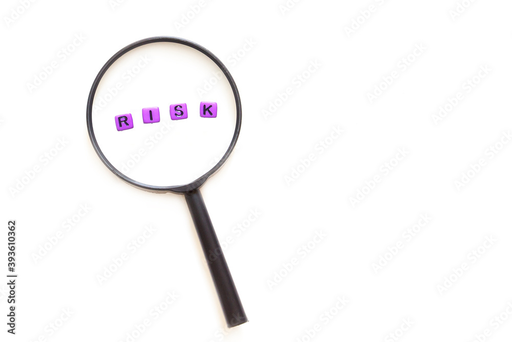 Magnifying glass with word RISK on white background , risk management concept Magnifying glass with word RISK on white background , risk management concept