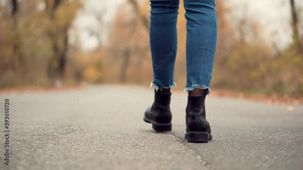 Female Feet Wearing Jeans And Shoes Walking On Road.Stylish Woman Resting Walk.Girl Legs On Casual Sneakers.Stylish Woman Legs In Leather Shoes Walking On Vacation Holiday In Cold Autumn Day. Female Feet Wearing Jeans And Shoes Walking On Road.Stylish Woman Resting Walk.Girl Legs On Casual Sneakers.Stylish Woman Legs In Leather Shoes Walking On Vacation Holiday In Cold Autumn Day.