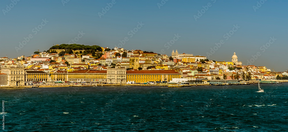 The Commercial Square, Castle Hill and Alfama district of Lisbon, Portugal viewed from the Tagus river