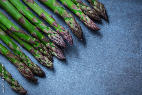 fresh green asparagus. Healthy eating concept. Food for vegetarians. Raw vegetables. Dark background. Free space for edits