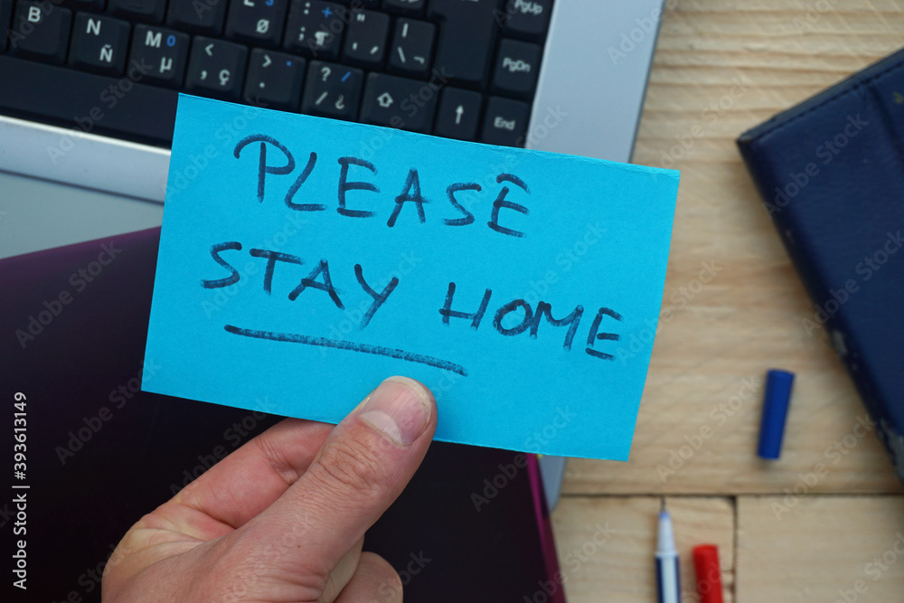 Please stay home written on a memo Please stay home written on a memo