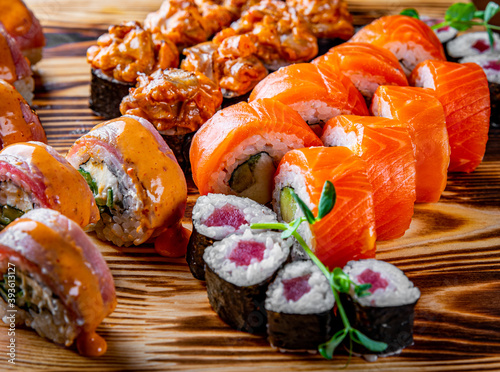 set of sushi roll with salmon, avocado, cream cheese, cucumber, rice, tuna