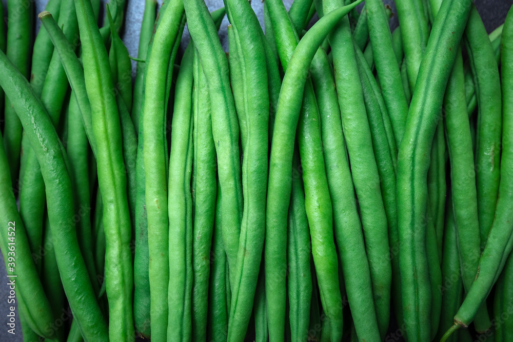 Green beans on grey stone background. Top view. Green beans on grey stone background. Top view.