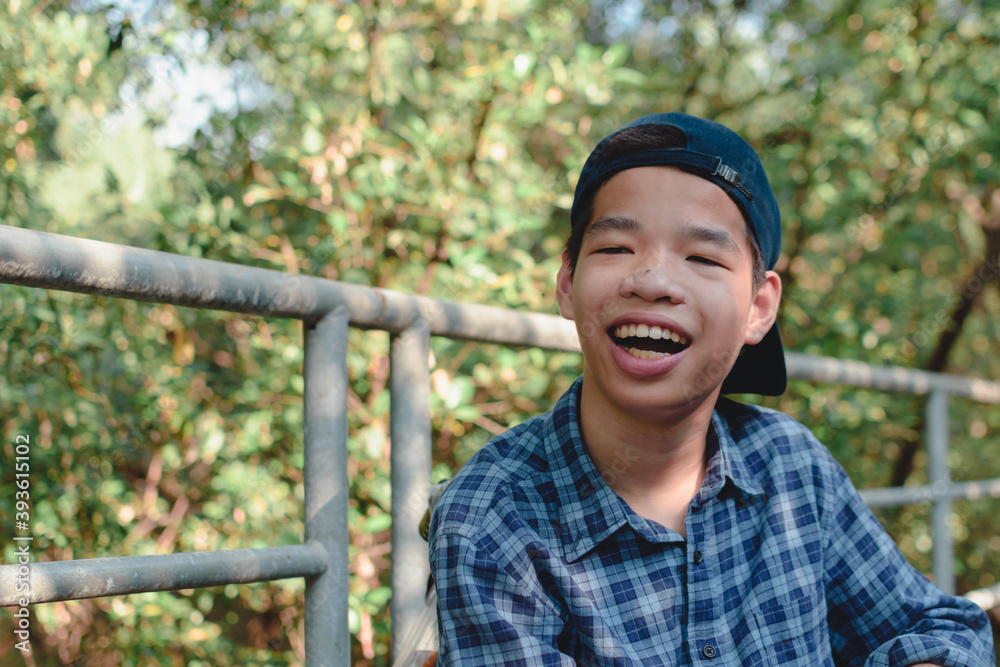 Asian special child on wheelchair is happily on mangrove forest background, Excited to travel on a holiday with family, Lifestyle in the education age of disabled children, Happy disabled kid concept. Asian special child on wheelchair is happily on mangrove forest background, Excited to travel on a holiday with family, Lifestyle in the education age of disabled children, Happy disabled kid concept.