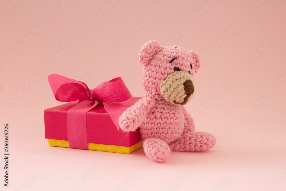custom made wallpaper toronto digitalsmall crochet bear in pink with a gift box on the back. Pink color. Love concept.